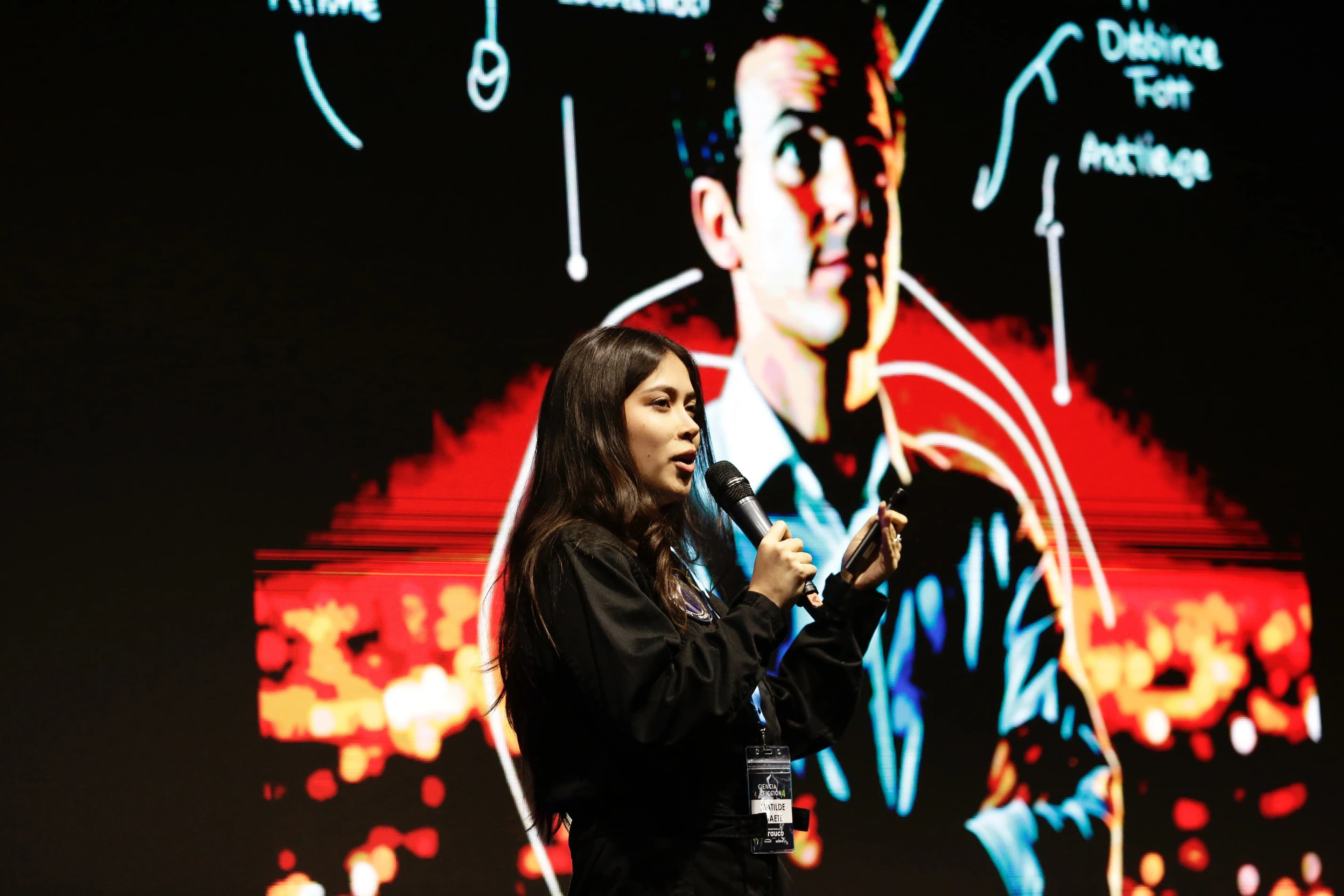 Matilde Gaete speaking at a conference with microphone